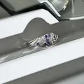 Macro view of oval ring featuring purple and white pavé-set stones on silver band - Oval Leaf Mixed Color Pavé Style