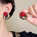 Dettaglio di orecchini vintage con stampa leopardata e perla rossa lucida - Orecchini a lobo con sfera rossa e leopardo (A2732)