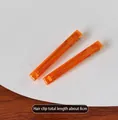Detailed view of two minimalist transparent orange duckbill clips, 8cm long - 2 Pcs/Set / Orange