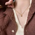 Macro view of a vintage tiger eye stone pendant necklace worn by a female model - Round Sweater Chain Style (X1467) / Gold