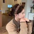 A detailed side view of a model wearing a soft plush brown leopard print headband - Plush Headband / Light Leopard