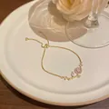 Elegant gold-tone adjustable slider bracelet featuring sparkling zircon flower design - Floral Branch Style (S733) / Gold