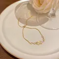 Elegant gold bracelet with cat's eye stone and zircon, featuring an adjustable chain. - Planet Cat's Eye Style (S757) / Gold