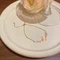 Elegant gold-plated four-leaf clover bracelet featuring zircon and cat-eye stones for women - Clover Style (S763) / Gold