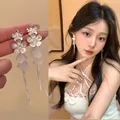 Elegant silver flower shell tassel earrings shown on an Asian model and product close-up - Double-Layer Flower Shell Tassel Style (A2603 Silver) / Silver