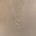 Double-layered silver-toned necklace featuring a radiant round green zircon pendant. - Double Layer Green Stone Style (X1688) / Silver