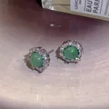 Elegant green gemstone stud earrings with sparkling halo zircon setting - Green Halo Style