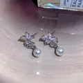 Elegant silver-toned flower stud earrings featuring sparkling zircon and a white pearl drop - Flower Pearl Style