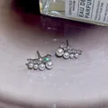 Elegant Korean style silver stud earrings with zircon and pearls on pink background - Pearl Croissant Style