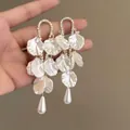 Elegant white petal tassel earrings featuring teardrop pearls and rhinestones in golden finish. - Large Drop Pearl Petal Style (A1804金)