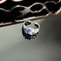 Detailed macro shot of an irregular textured silver ring with oval blue crystal center - Blue Oval Textured Style (13号)