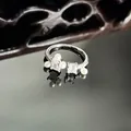 Close-up of an elegant silver-tone open ring with pearls and square cubic zirconia. - Pearl and Baguette Cut Style (16号)