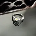Detailed macro shot of a silver Saturn ring with iridescent opal and star accents - Starry Sky Saturn Style (17号)