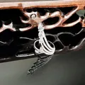 Close-up detail of an elegant silver snake-shaped ring with shimmering white stone pavé. - Pear Cut Main Stone Style (18号)