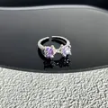 Detail view of a silver bow ring featuring sparkling purple marquise-cut crystals - Style 5