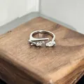 Detailed view of silver open ring featuring marquise-cut and round cubic zirconia - Double Stone Intertwined Style (89911551)