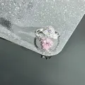 Detailed macro view of an adjustable silver ring with pink and clear heart zircons. - Dual Heart Pink Clear (Style 2)