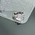 Detailed view of the double pear-shaped pink and clear zircon stones on the ring. - Side by Side Twin Pear (Style 4)