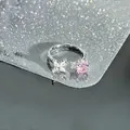 Macro view of adjustable silver ring featuring pink round stone and white zircon flower detail - Round Pink with White Cluster (Style 5)
