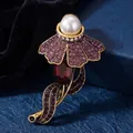 Vintage gold-tone jellyfish brooch featuring a large pearl and purple shimmering crystals. - Antique Gold Purple Rhinestone Red Rhombus Main Stone Jellyfish Style (824410)