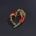 Macro detail of an elegant heart-shaped brooch featuring red berries and green enamel leaves - Red Heart