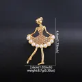 Detailed view of an elegant ballerina girl brooch with pearls and gold finish design - KC Gold, Peach + Beige Pearl