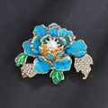 Elegant blue peony brooch with central pearl and rhinestones on dark background. - Blue