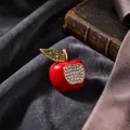 Elegant red apple brooch with green leaf rhinestones on dark velvet cloth background - Red Apple / KC Gold