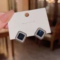 Close-up of elegant square blue zircon stud earrings featuring a micro-pave halo detail - Blue Zircon Square Style (A810)