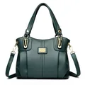 Bolso de mano elegante en cuero granulado verde oscuro con doble asa. - Verde