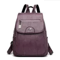 Stylish women's purple soft leather backpack featuring a kangaroo logo and flap closure - Violet