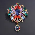 Vintage gold-tone alloy brooch with colorful rhinestones and deep blue teardrop pendant - Colorful