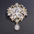 Vintage golden alloy brooch featuring clear crystals and an elegant teardrop pendant - White (Gold Base)