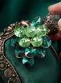 Elegant green grape brooch with faceted glass crystals on vintage dark green background - Vintage Exquisite Style / Green Grapes