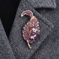 Luxurious leaf-shaped brooch with purple crystals pinned on a grey wool coat lapel - Color-Preserving Gold Purple Rhinestone Two Main Stones Leaf Style (XD823174-2)