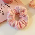 Detailed macro shot of a fuzzy pink knit scrunchie on a minimalist pink aesthetic background - Pink Knit