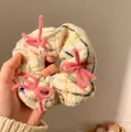 Close-up macro view of a plush plaid scrunchie with soft pink bow details for winter - Plaid Bow / Approx. 10cm