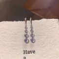 Elegant silver drop earrings with four graduated brilliant cubic zirconia stones - Graduated Round Rhinestone Tassel Style (E6789)
