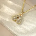 Close-up of gold iced-out initial A pendant necklace with micro-pave stones. - Letter A / Champagne Gold
