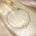 Detailed macro view of a stylish gold titanium steel bracelet with a letter C charm - Letter C Style / Gold