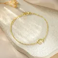 Close-up of golden titanium steel bracelet featuring a minimalist letter G charm detail. - Letter G Style / Gold
