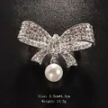 Elegant silver bow brooch featuring a white pearl pendant and sparkling clear rhinestones - Pave Rhinestone Bowknot With Pearl (XD7706-2) / 3.5x4.3cm / Bowknot Pendant Pearl (Silver)