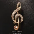 Elegant gold-tone musical note brooch pin with champagne and clear rhinestones - Music Note Style (XD9424-3) / Gold/Champagne