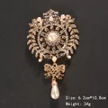 Elegant gold-tone ornate brooch featuring sparkling rhinestones and a lustrous pearl drop pendant - Court Pendant Style (XD7208-1) / Size: 6.2x10.8cm / Gold