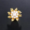 Elegant gold-tone snowflake brooch featuring white pearls for stylish apparel accents - Gold Base with Pure White Pearl