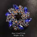 Elegant circular wreath alloy brooch with deep blue crystals on black textured background - 5.1x5.1cm / Gold Royal Blue Zircon