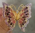 Close-up detail of an elegant butterfly brooch with colorful sparkling rhinestones - Purple Butterfly Style (XD825245) / Gold