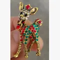 Detailed close-up view of a gold-tone deer brooch inlaid with red and green rhinestones. - Colorful Deer Style (XD825248)