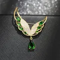 Elegant gold angel wing brooch featuring green teardrop zircon pendant and pavé crystals - Gold Base / Green