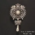 Ornate silver brooch pin with crystals and drop pearl on a black background - Court Pendant Style (XD7208-2) / Size: 6.2x10.8cm / Silver